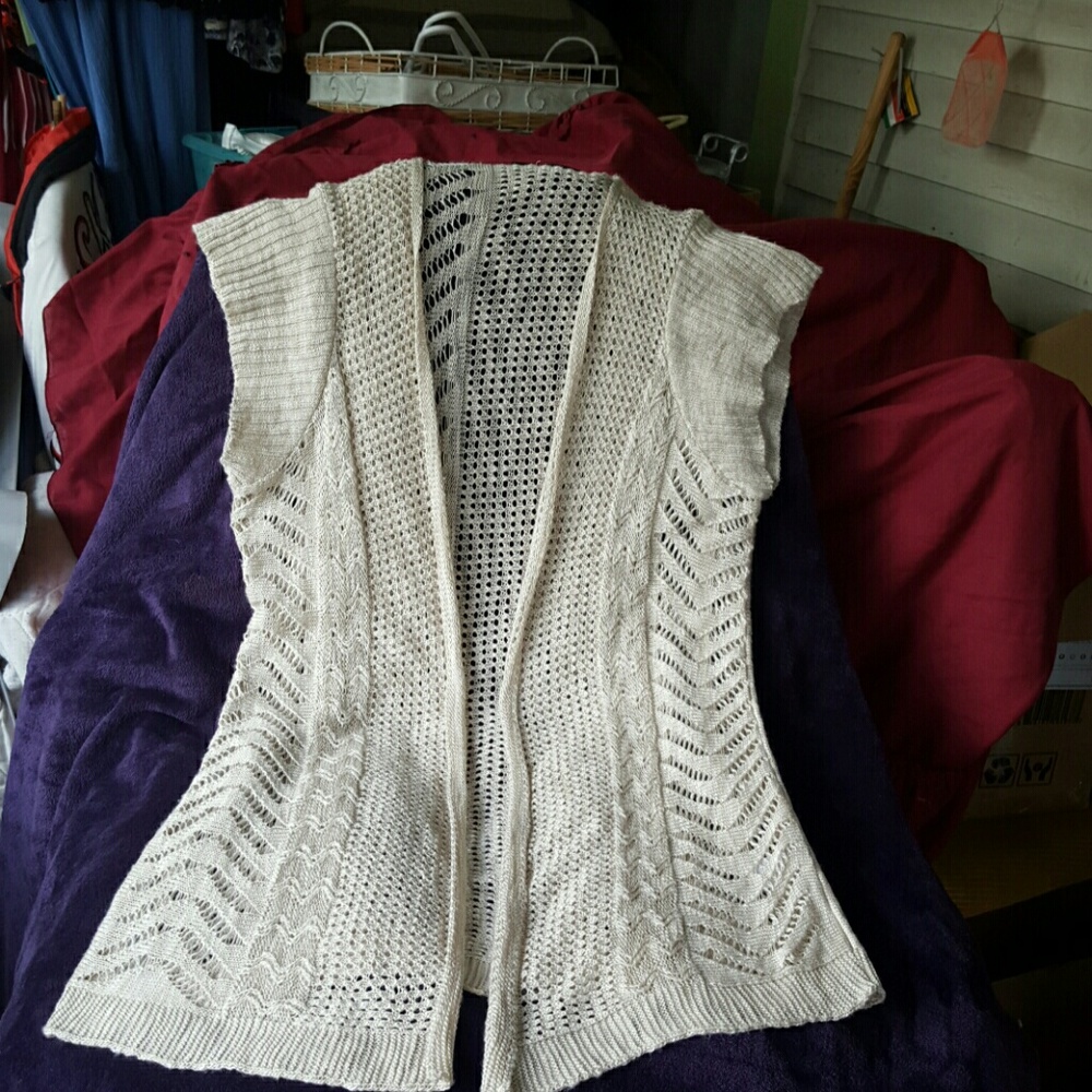 Crocheted cardigan cream in color.